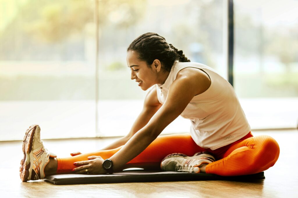 pexels-photo-3076509-3076509 A woman enjoying a yoga stretch indoors, promoting a healthy lifestyle.